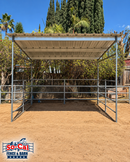 A SoCal Fence and Barn metal horse shelter with a PBR panel roof, set in a sandy outdoor paddock with trees and a blue sky in the background.